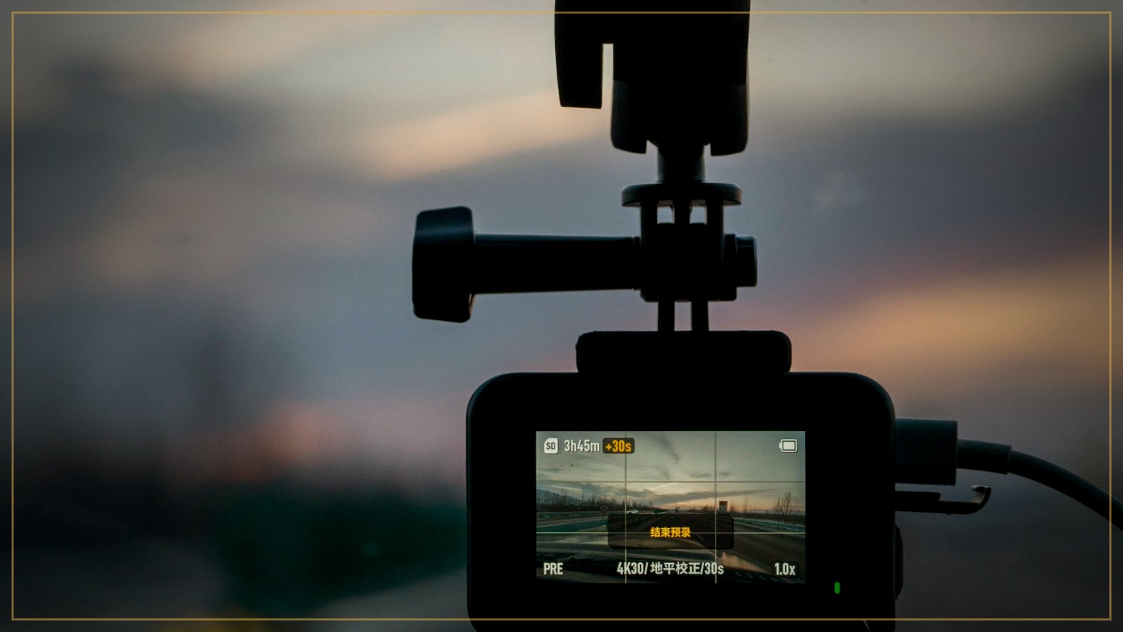 Dash camera mounted on a windshield at sunset