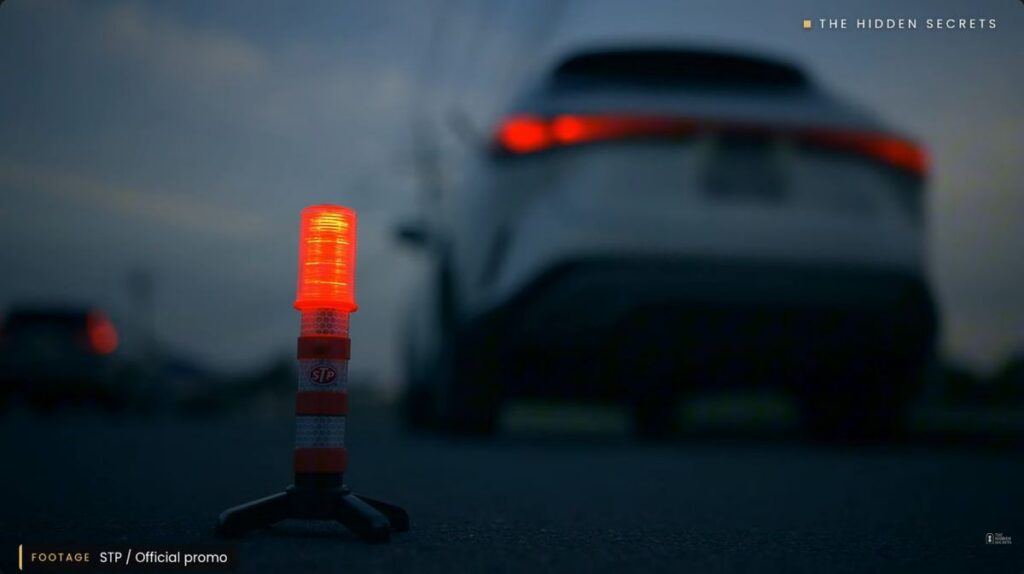 STP LED road flare behind a car at dusk